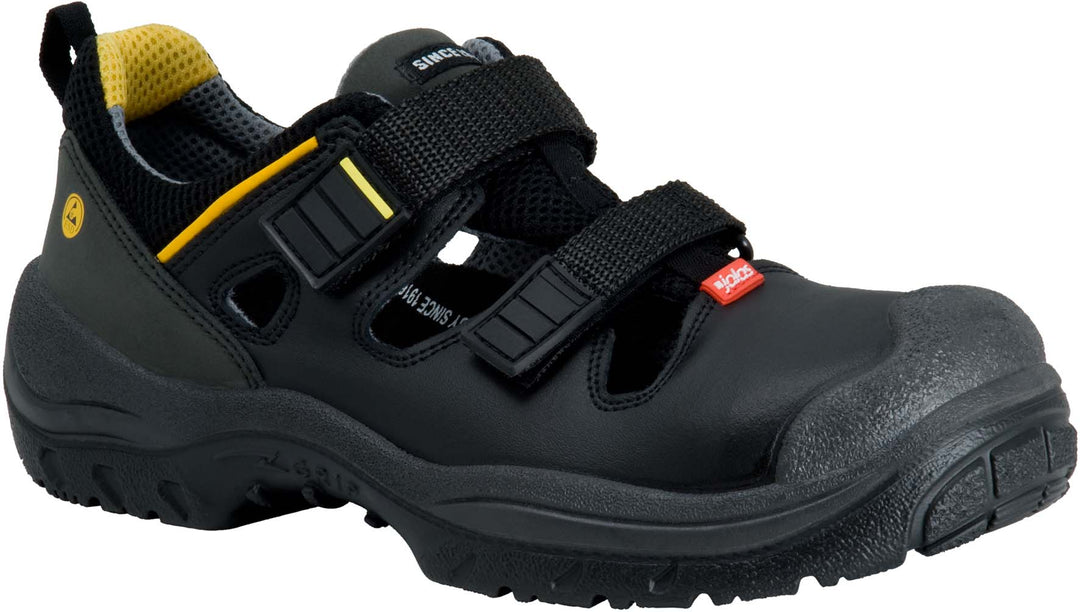 Musta Jalaksen pintanahkainen matala  Monza grip- turvakenkä. Edessä tarrakiinnitys. Sivussa keltainen koristeraita. Edessä pieni punainen Jalaksen merkki. Välipohja tummanharmaa, ulkopohja musta.