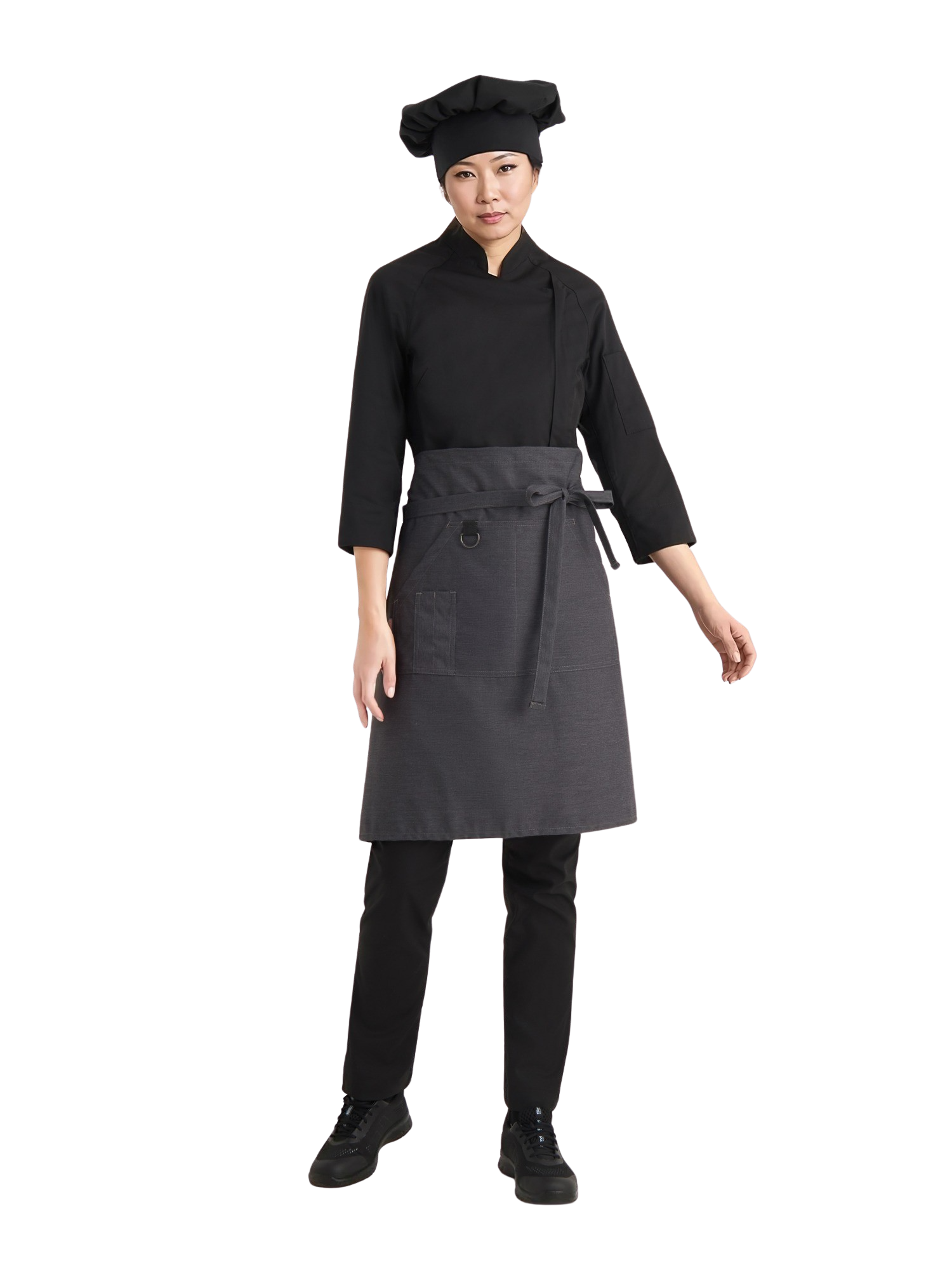 Kuvassa naismallilla musta kokintakki, reisitaskuhousut ja kokin hattu sekä harmaa bistro esiliina. Jalassa mallilla on Sievin Fly fresh-työlenkkarit. 