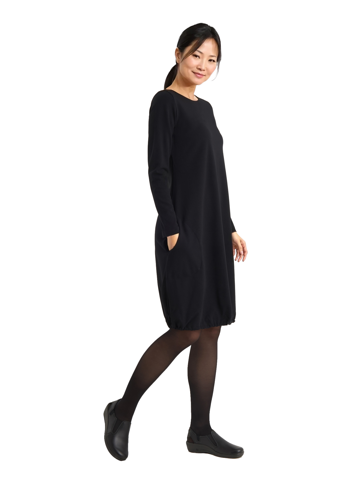 Kuvassa naismallilla päällä Image Wearin musta pitkähihainen ja taskullinen neulosmekko, jossa helmassa kiristysnauha. Jalassa mallilla on Image Wearin Rumba-nimiset työkengät.