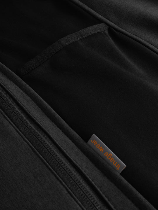 Yksityiskohtakuva softshell-takin sivuosasta. Väritys meleerattu musta. 