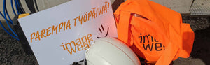 Image Wear työvaatteet, oranssi huomiokassi sekä Parempia Työpäiviä! -toivotus.